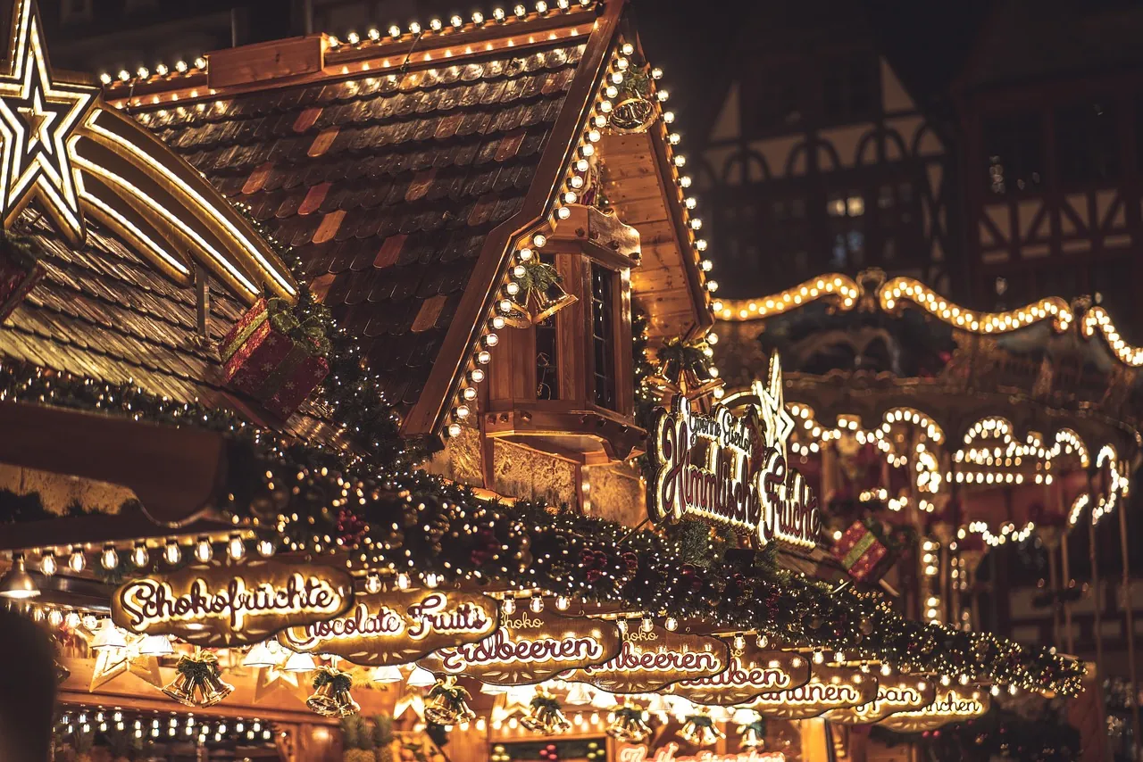 Illuminated German Christmas market stalls at dusk